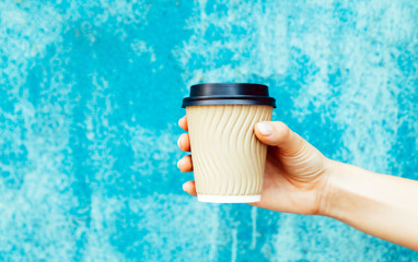 Cup of cappuccino in female hand.
