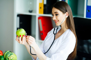 Health. Healthy Eating. The nutritionist holds in the hands of Fresh Green Apple. Fresh Vegetables...