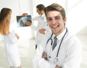 young doctor on the background of colleagues