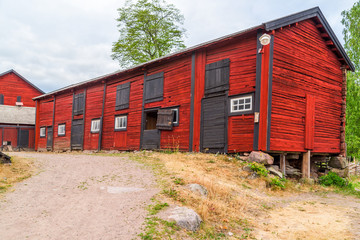 Traditional red and black wooden barn. © imfotograf