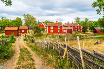 The historic village of Stensjo in Smaland, Sweden, as seen from a nearby country road. - obrazy, fototapety, plakaty