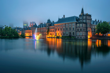 Fototapeta na wymiar The Binnenhof palace in a foggy evening in Hague, Netherlands