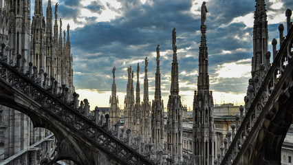 Fototapeta premium Roof terraces of gothic Milan Cathedral (Duomo) at sunset, Italy