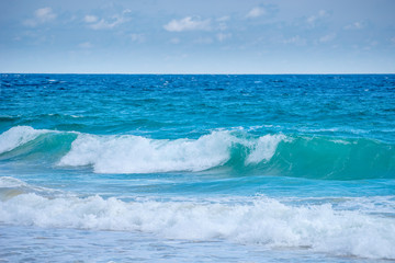 Fototapeta premium Sea view from tropical beach with sunny sky. Summer paradise beach of Bali island. Tropical shore. Tropical sea in Bali. Exotic summer beach with clouds on horizon. Ocean beach relax, Outdoor travel