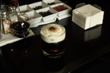 White Russian Cocktail with coffee beans and cinnamon garnished .
