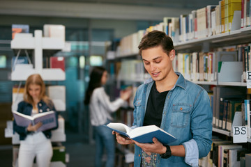 Student Of University Reading Book In Library