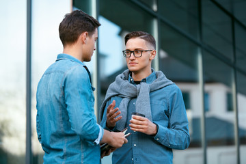 Young Men Talking Near Office Building