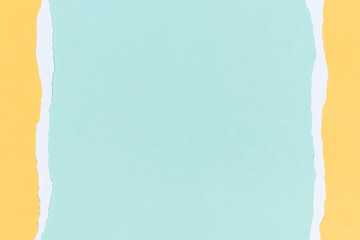 top view of empty ripped yellow paper on turquoise