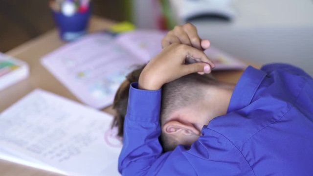 Schoolboy got a bad grade on test work, sad emotion.
