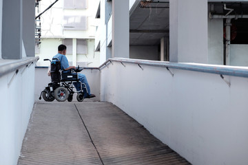 Lonely Disability Old Man on an Electric Wheelchair in the Hospital.