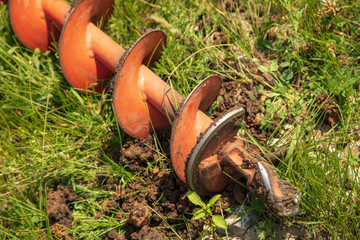 Worker drills the ground at the construction site