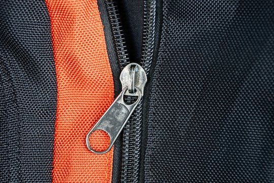gray metal buckle on a black red backpack