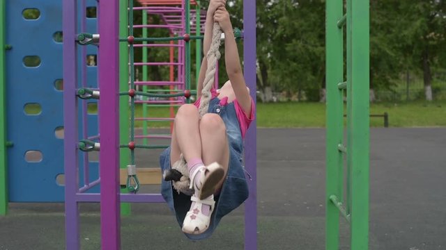 5-year-old girl hanging on a rope
