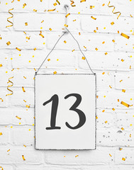13 years old birthday party card with number thirteen with golden confetti