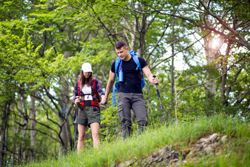 Fototapeta na wymiar Couple of hikers have fun on their hiking trip