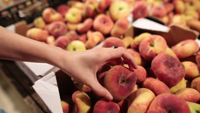 Fresh saturn peaches or donut peaches in the store market.
