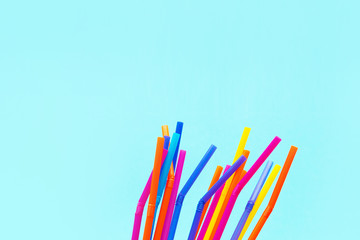 Colorful drinking straws on blue background