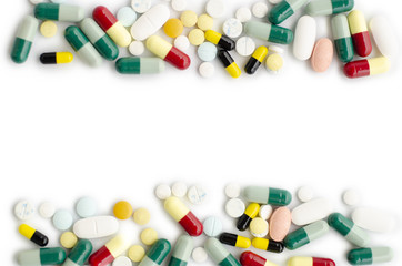 Green and yellow and blue pill or capsule on a white background.