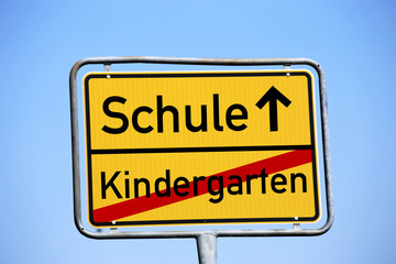 Ortsausgangsschild mit dem Schriftzug Kindergarten / Schule