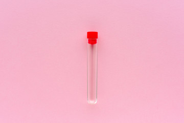 Empty specimen tube on pink background
