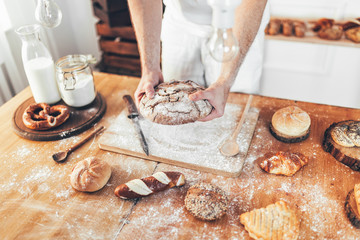 Baker with a variety of delicious freshly baked bread and pastry