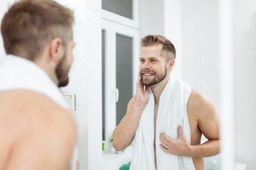Morning hygiene, Man in the bathroom looking in mirror