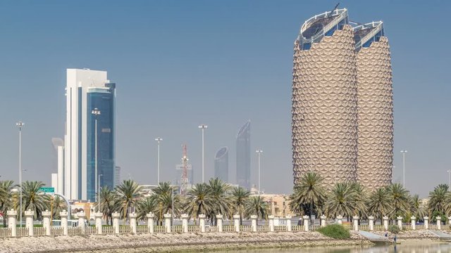 View of skyscrapers skyline with Al Bahr towers in Abu Dhabi timelapse. United Arab Emirates