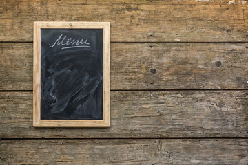 Menu chalkboard on rustic wooden wall