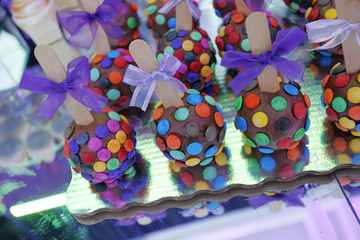 Set of cupcakes around a wedding table. A cupcake is a small cake designed to serve one person and uses ingredients as butter, sugar, eggs, and flour, as well as raisins, nuts, or chocolate chips.