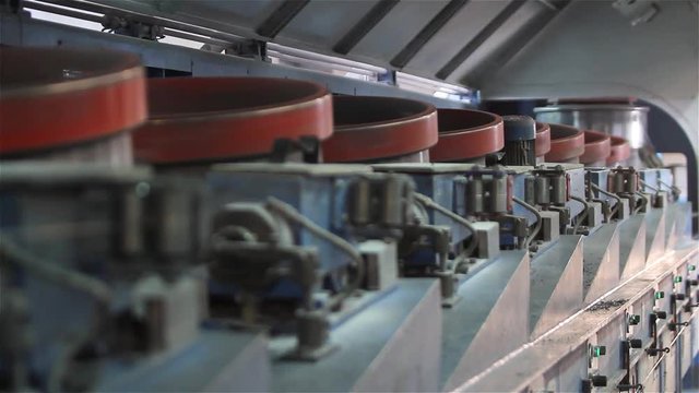 Manufacture of springs for orthopedic mattresses, giving of a wire close up, production of springs, metal wire on the drum, metal spring coil close up, factory for the production of mattresses