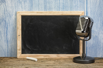 Blank vintage chalkboard and retro microphone