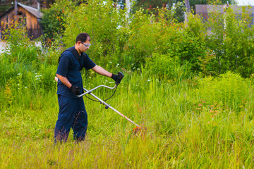 man mowing grass with a lawn mower