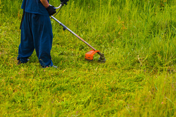 man mowing grass with a lawn mower