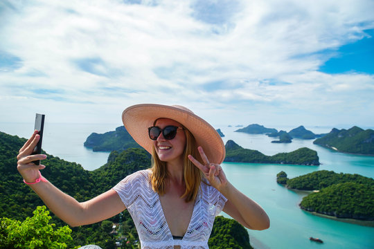 Female Traveler Taking Selfie with Tropical Islands at Angthong National Marine Park in Thailand
