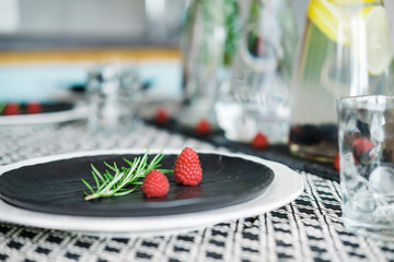 Water in glass decanters with oregano and served table
