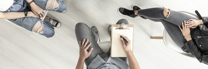 Top view of rebellious teenagers during therapy with psychologist