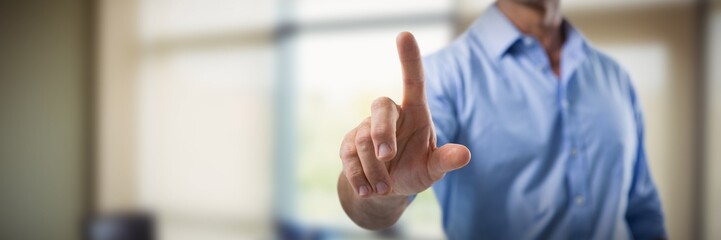 Male executive pressing an invisible virtual screen against