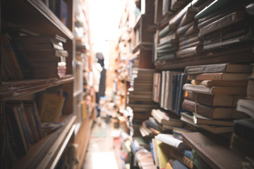 Book shelves with stacks of books. The atmosphere of the old library