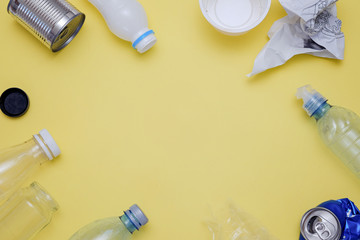 Eco concept with recycling symbol and garbage on table background top view