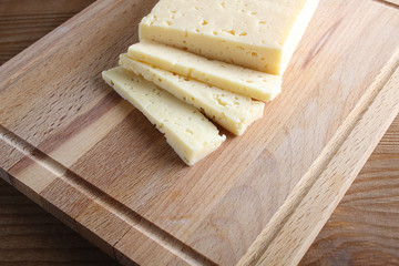 cheese cut on a wooden background