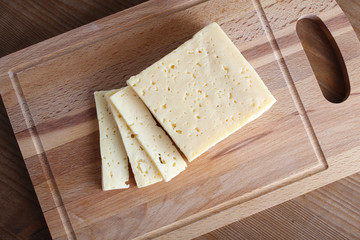 cheese cut on a wooden background