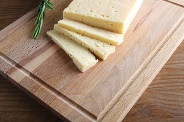 cheese cut on a wooden background