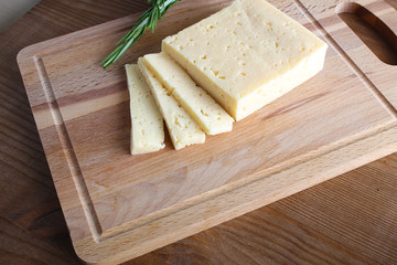 cheese cut on a wooden background