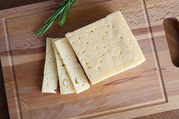 cheese cut on a wooden background