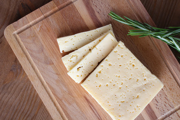 cheese cut on a wooden background