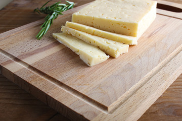 cheese cut on a wooden background