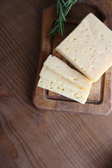 cheese cut on a wooden background