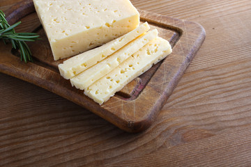 cheese cut on a wooden background