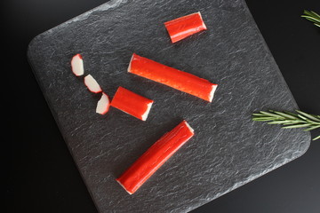 crab sticks on a dark background