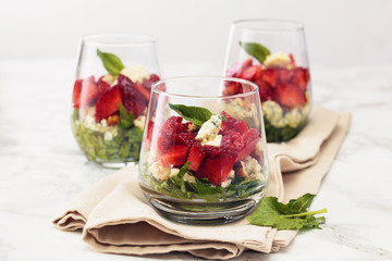 Spinach salad in glass.